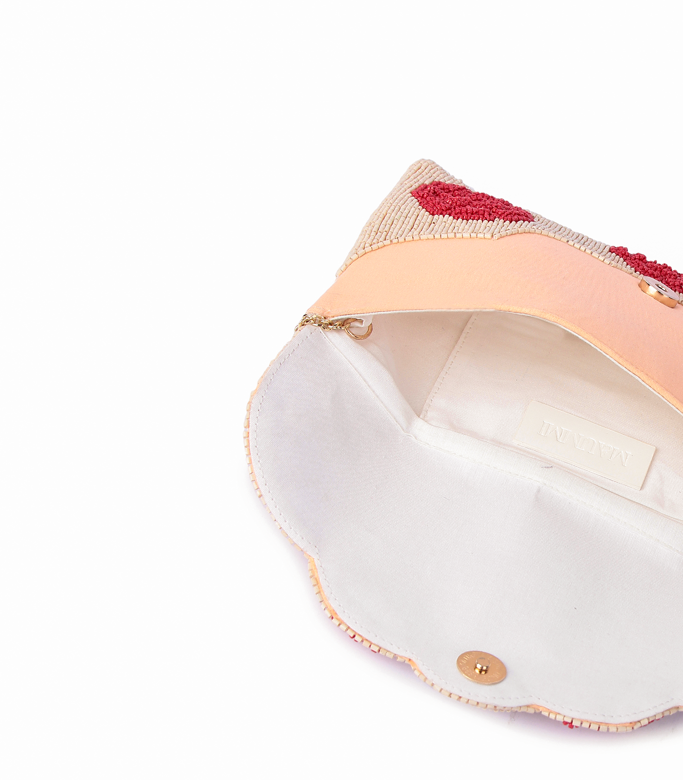Close-up of a pink clutch with decorative trim on a white background