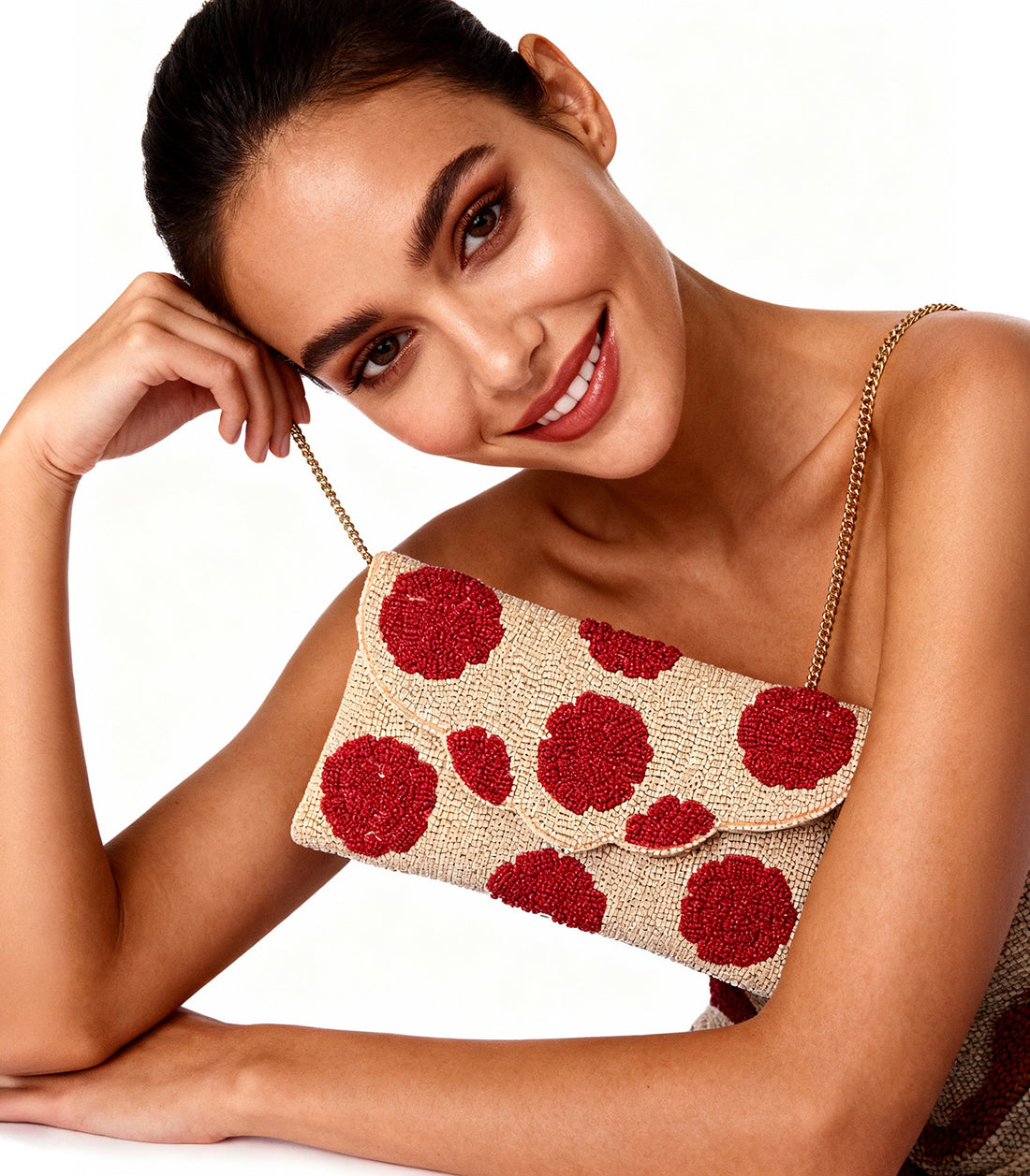 Clutch bag with red floral pattern on a beige background