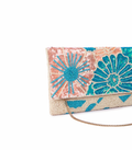 Floral beaded clutch bag with a chain strap on a white background