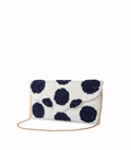 White clutch bag with black polka dots on a white background