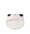 White visor with black polka dots and gold accents on a white background