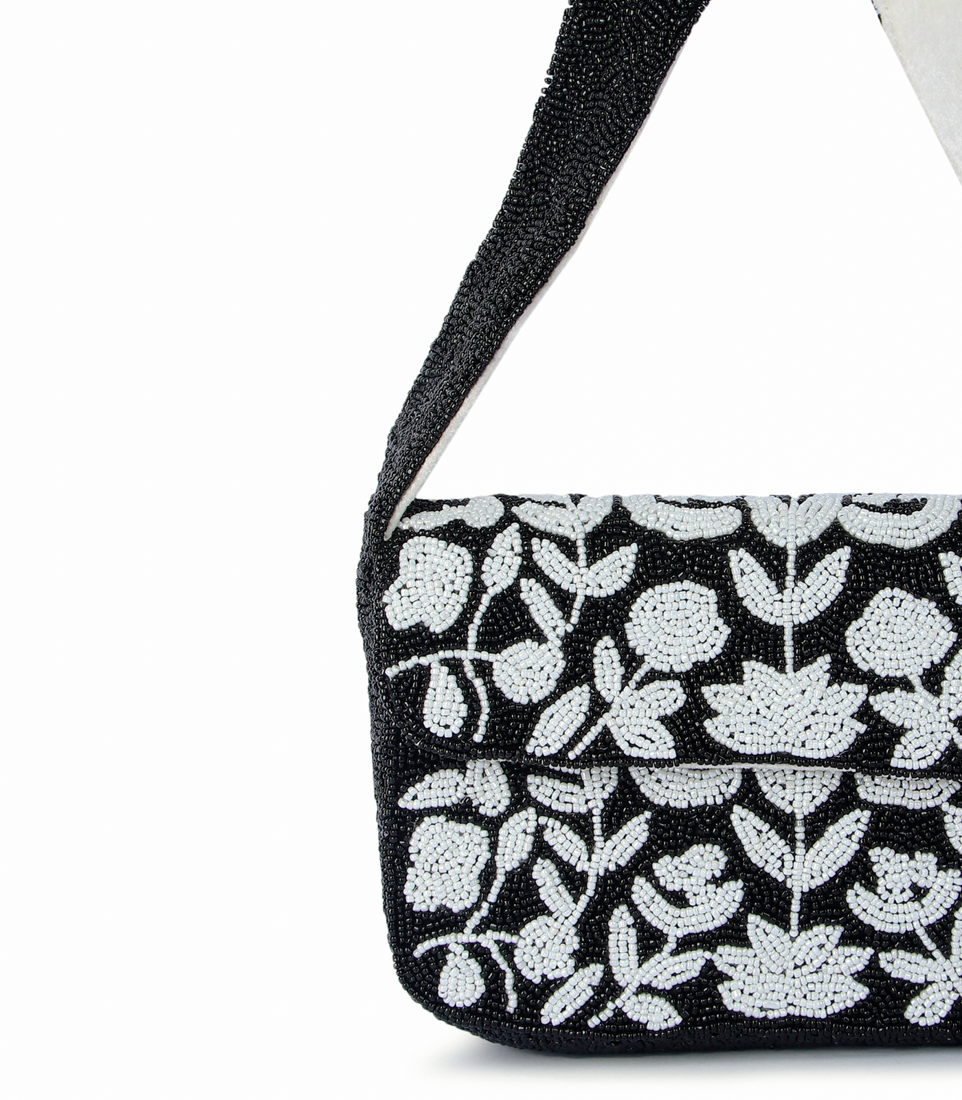 Black handbag with white floral pattern on a white background