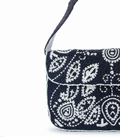Black beaded handbag with white patterns on a white background