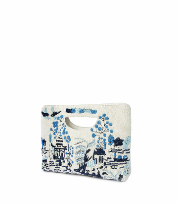 White clutch bag with blue floral embroidery on a white background